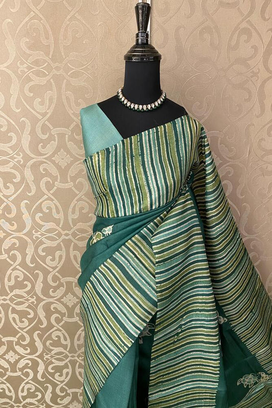 Deep green tussar silk printed saree with unstiched blouse, traditional wear from Saarang Sarees featuring intricate design.