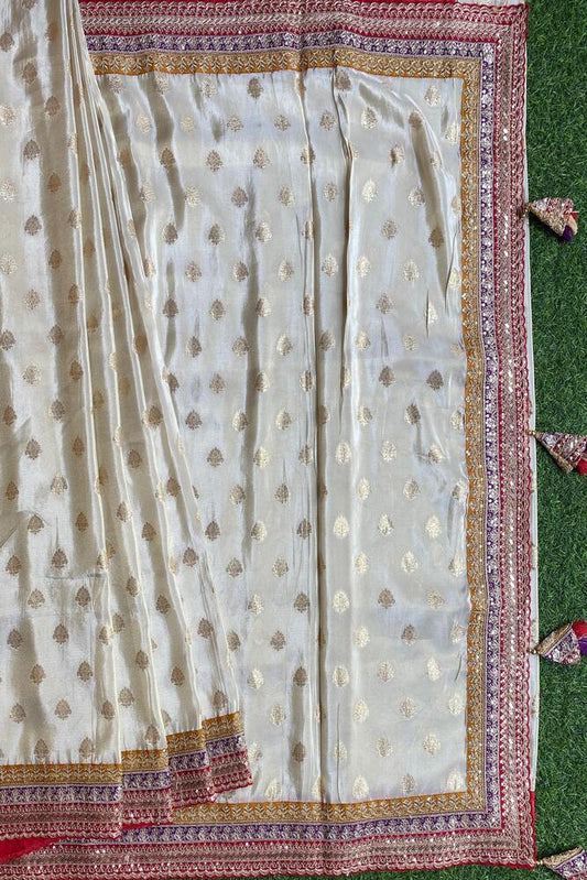 Off-White Gold Tissue Khaddi saree with embroidered border and unstiched blouse, traditional wear by Saarang Sarees.