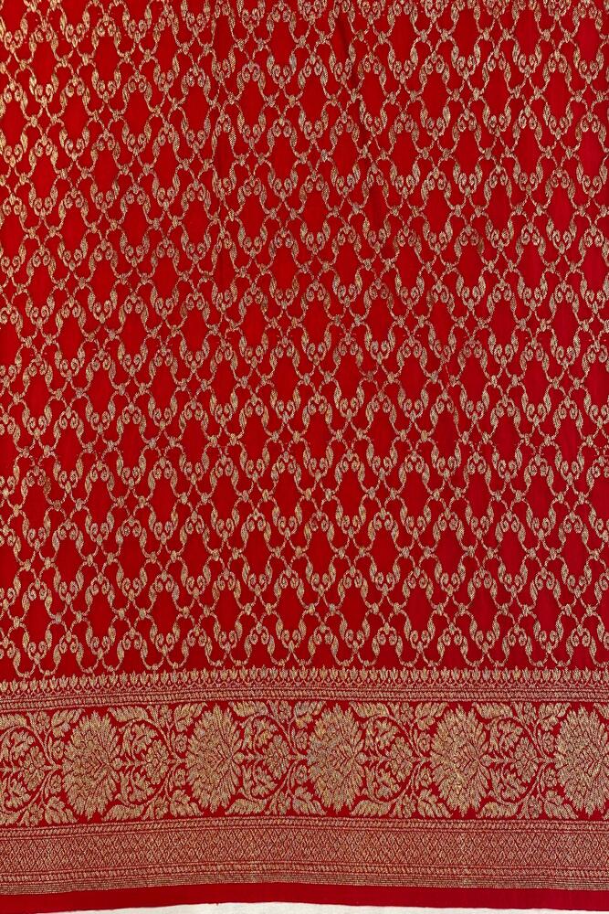 Cherry red Mysore crepe silk Banarasi saree with intricate gold zari work and an unstiched matching blouse, traditional Indian wear.