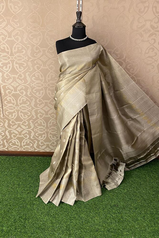 Beige pure Kanjeevaram silk saree from Saarang Sarees with intricate traditional patterns and an unstiched matching blouse.