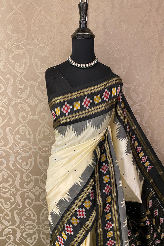 Off-White Pochampally Ikat silk saree with intricate patterns and a matching unstiched blouse, traditional Indian attire by Saarang Sarees.
