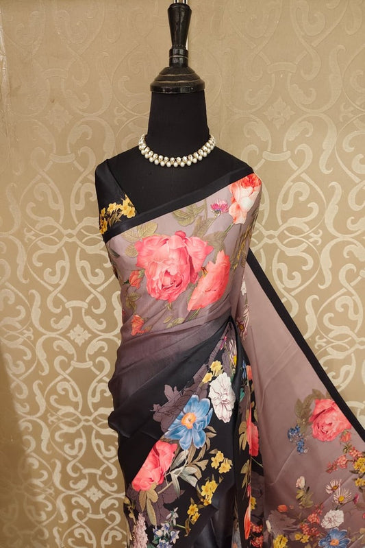 Black and multi-color floral printed satin crepe saree from Saarang Sarees, with an unstiched blouse, ideal for party wear.
