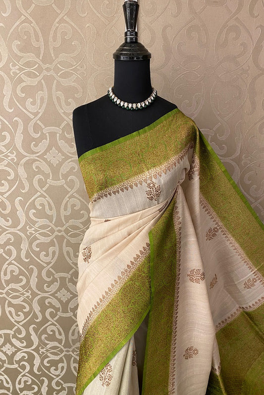 Offwhite Tussar Banarasi silk saree with handwoven motifs and unstiched blouse, traditional wear by Saarang Sarees.