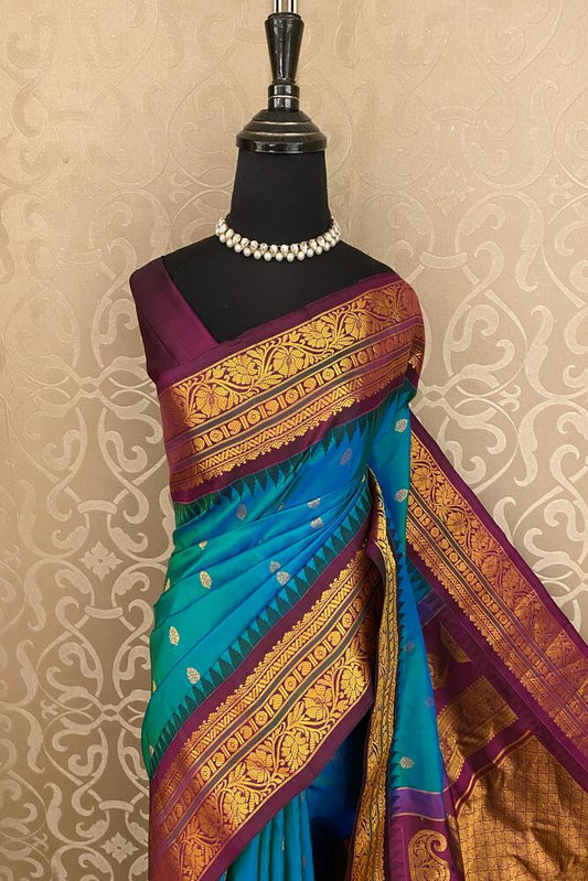 Peacock blue Gadwal silk saree with traditional design and unstiched blouse from Saarang Sarees, showcasing intricate woven patterns.