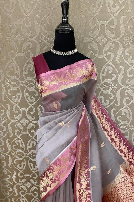 Grey and pink muslin Kora Banarasi silk saree with an unstiched blouse from Saarang Sarees, showcasing intricate traditional weaving.