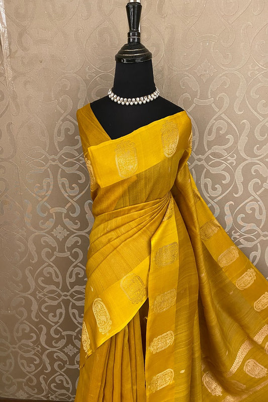 Mustard yellow tussar handloom saree with mashru border and matching unstitched blouse, traditional wear by Saarang Sarees.