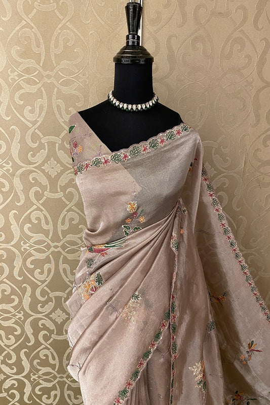 Grey tissue saree with intricate Aari work and unstitched blouse, perfect for party wear by Saarang Sarees.