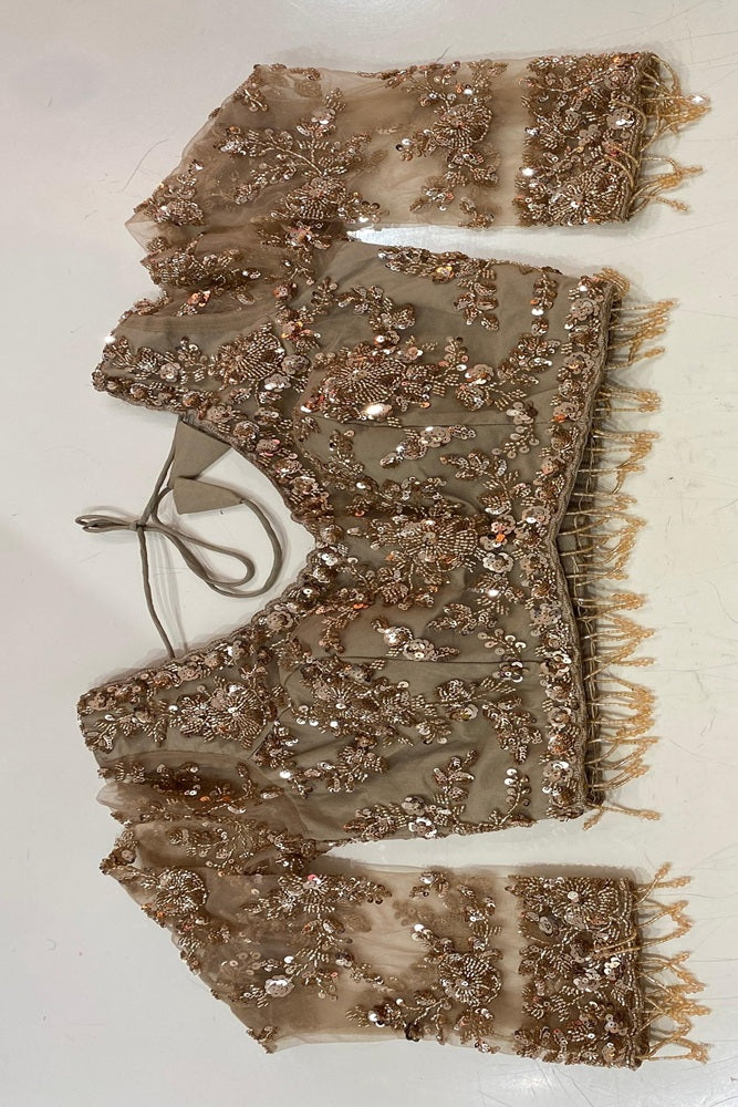 Golden party wear net embroidered saree with blouse piece by Saarang Sarees, showcasing intricate embroidery and elegant draping.