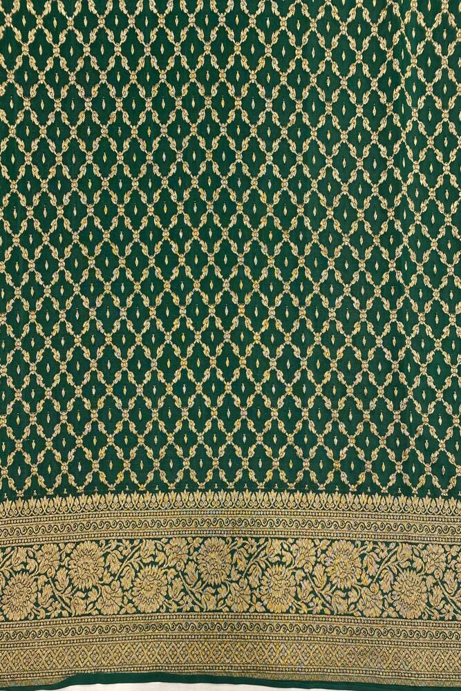 Deep green Mysore crepe silk Banarasi saree with intricate gold zari work and an unstiched blouse for traditional wear.