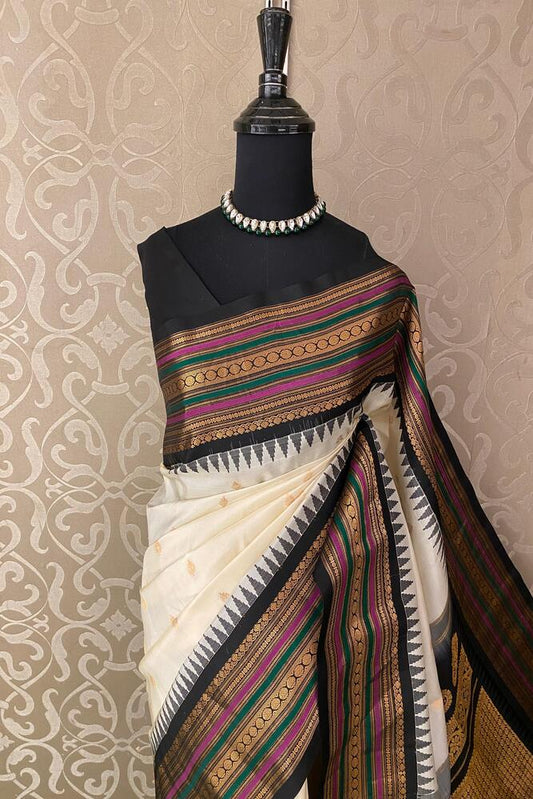 Off-White Gadwal Silk Saree from Saarang Sarees with a matching unstiched blouse, showcasing intricate traditional weaving and elegant drape.