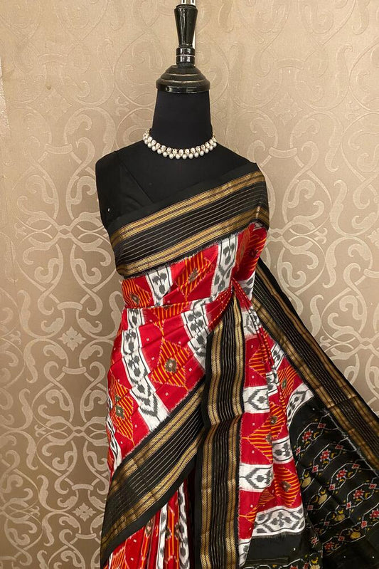Red and multi-colored Pochampally Ikat silk saree by Saarang Sarees with an unstiched blouse, showcasing intricate traditional weaving.