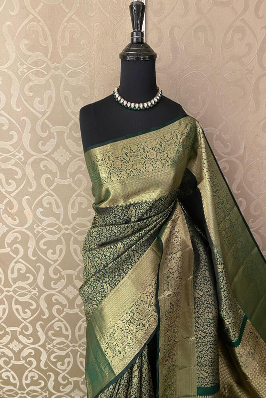 Forest green pure Kanjeevaram silk saree with intricate traditional patterns and matching unstiched blouse from Saarang Sarees.