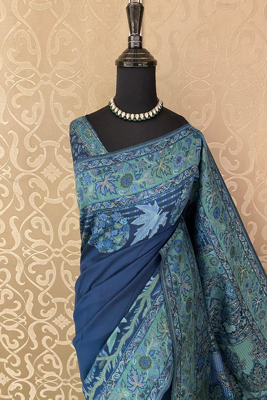 Navy blue pure Kani handloom silk saree with floral woven blouse, traditional wear by Saarang Sarees, unstitched blouse visible.