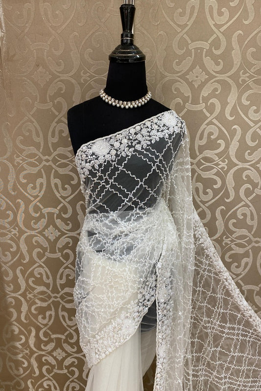 White party wear net embroidered saree with matching blouse piece from Saarang Sarees, featuring intricate embroidery and elegant drape.
