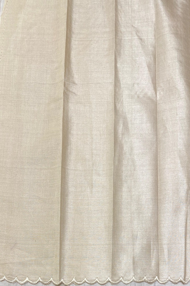 Off-White Tussar saree with applique work and unstiched blouse from Saarang Sarees, traditional wear shown in the image.