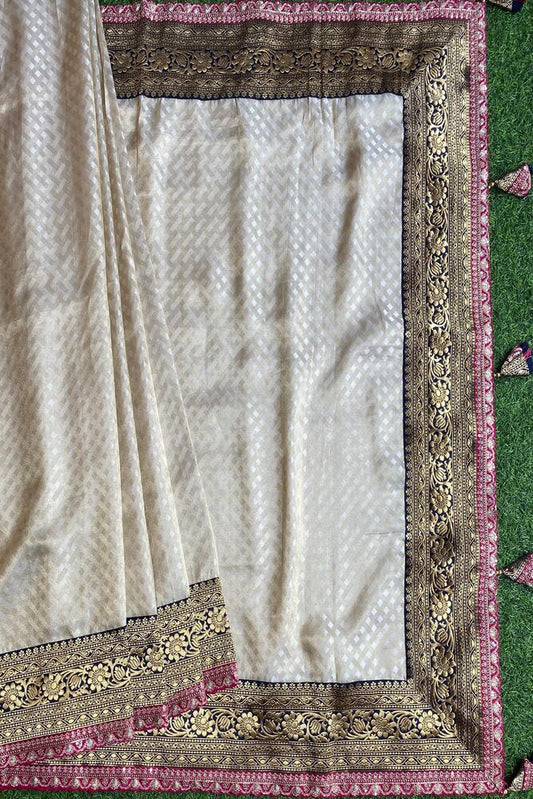 Off-White Gold Tissue Khaddi saree with embroidered border and matching unstiched blouse, traditional wear by Saarang Sarees.