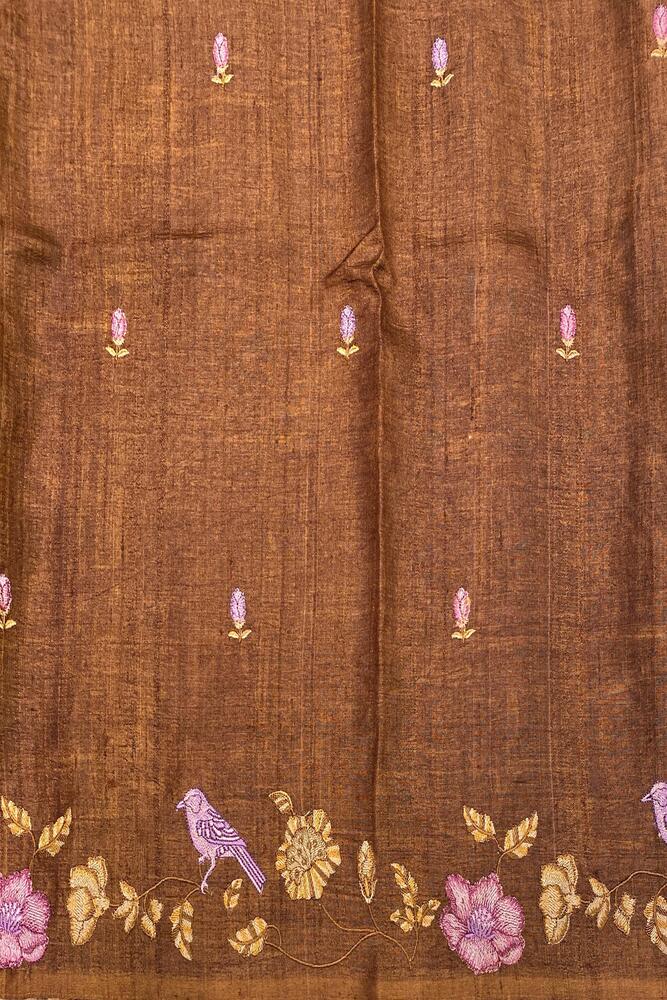 Brownish yellow Tussar Resham embroidery saree with matching unstiched blouse, traditional wear by Saarang Sarees, detailed embroidery visible