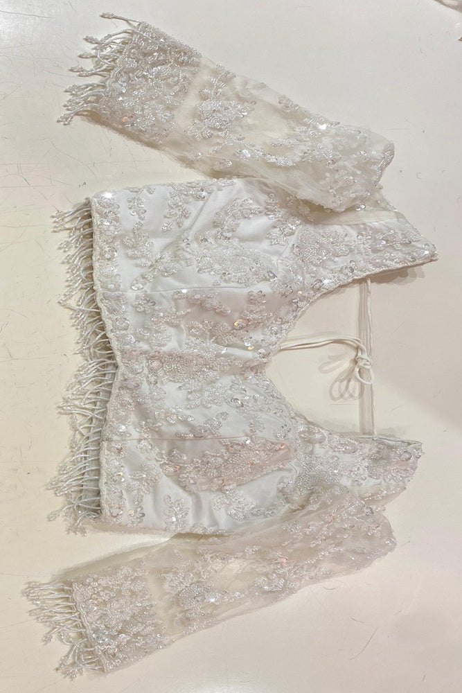 White party wear net embroidered saree with matching blouse piece by Saarang Sarees, featuring intricate embroidery and elegant drape.