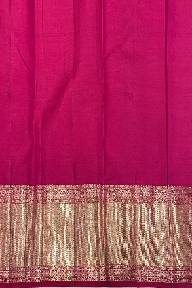 Magenta pure Kanjeevaram silk saree with intricate gold zari work and matching unstiched blouse, traditional South Indian wear.