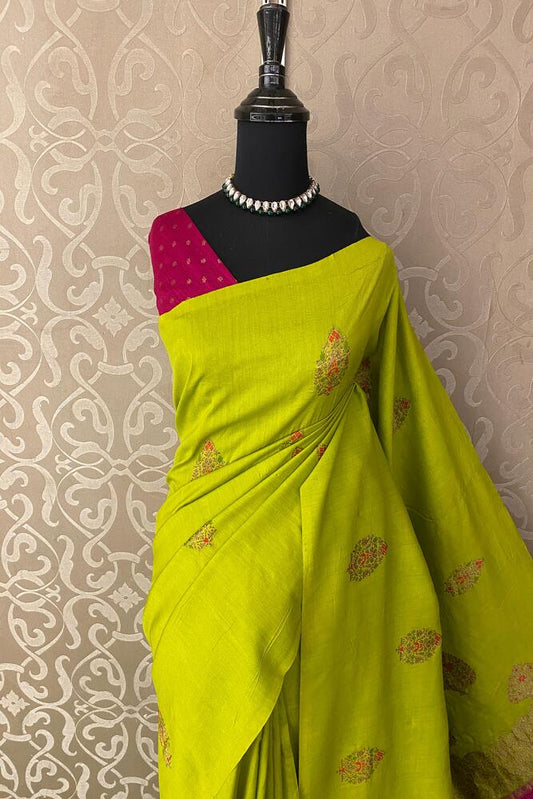Lime green Munga Banarasi silk saree with intricate gold zari work, paired with an unstitched blouse for traditional wear.