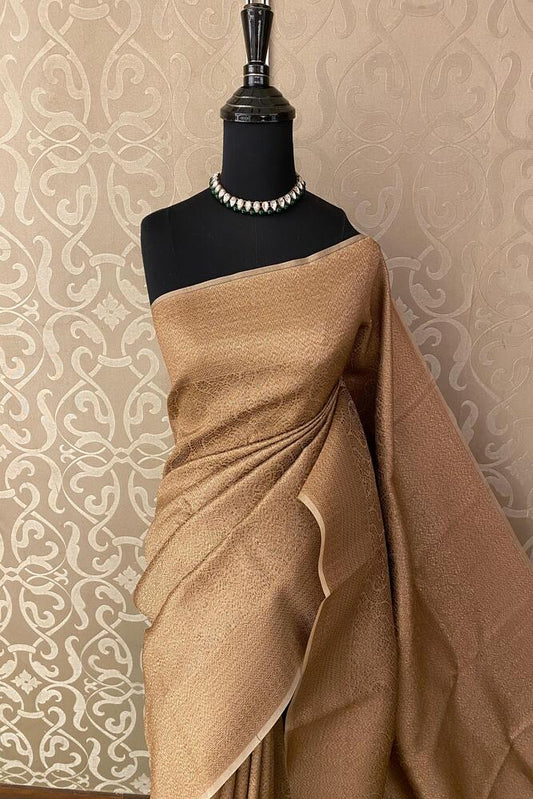 Beige Brocade Kora Banarasi silk saree with intricate gold patterns and unstiched blouse, traditional wear by Saarang Sarees.