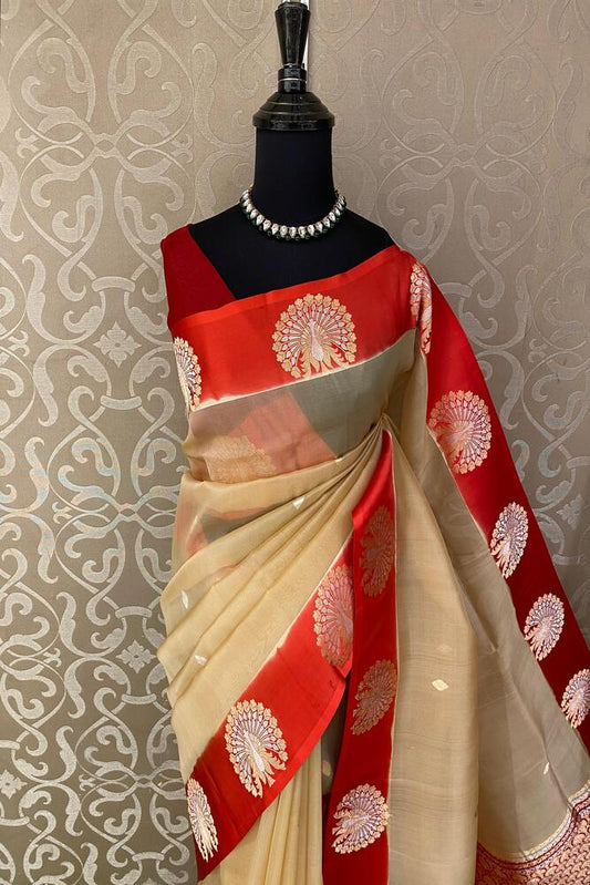 Beige and red muslin Kora Banarasi silk saree with intricate traditional design and unstiched blouse from Saarang Sarees.