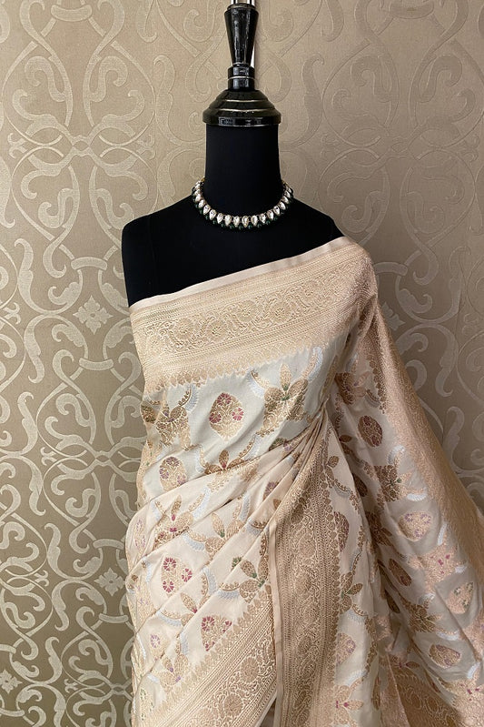 Off-White Uppada Banarasi saree with intricate gold zari work and matching unstiched blouse, traditional Indian wear by Saarang Sarees.