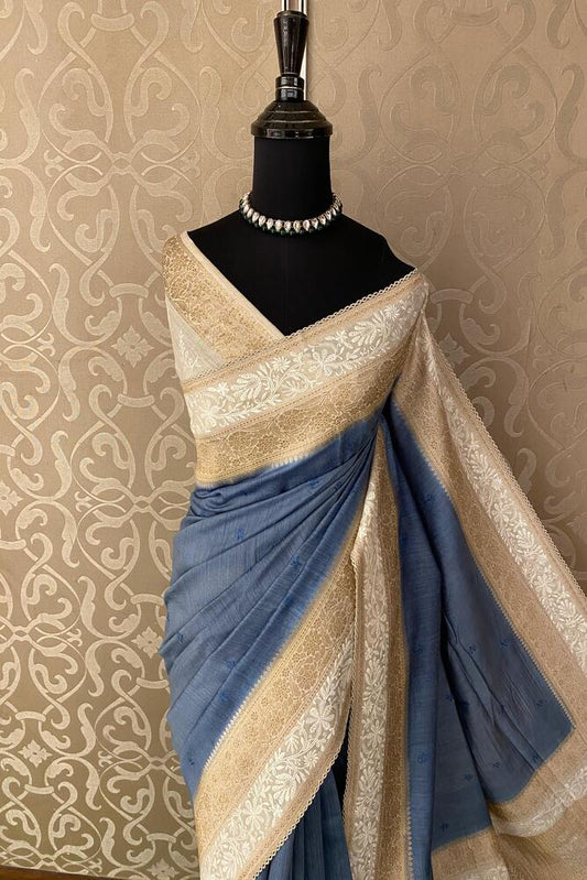 Powder blue Munga Banarasi silk saree with hand-woven motifs and matching unstiched blouse, traditional wear by Saarang Sarees.
