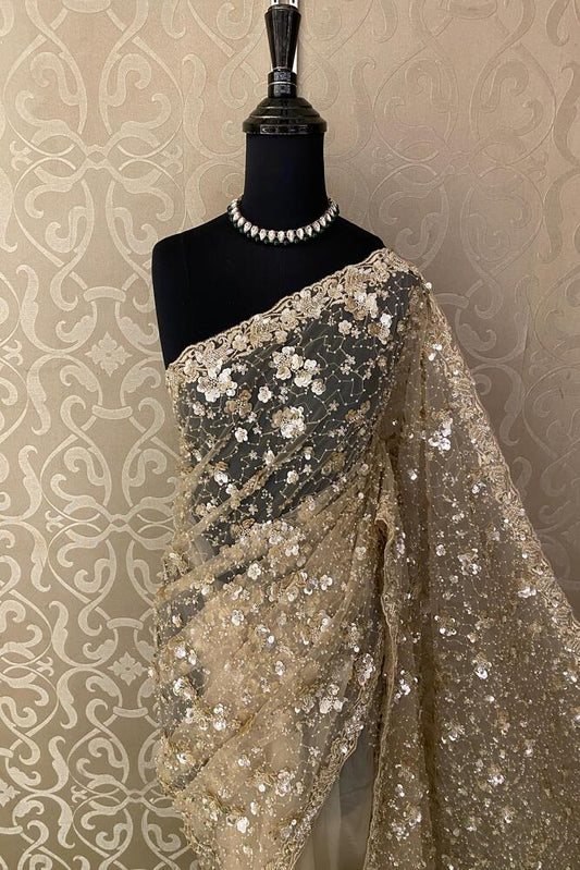 Off-White party wear net embroidered saree with a matching readymade blouse, featuring intricate embroidery and elegant drape.