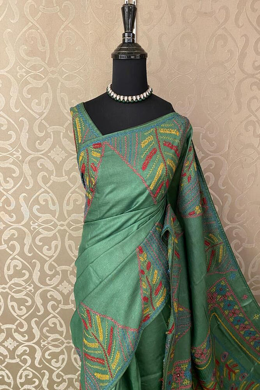 Deep green Tussar embroidery saree with Lambani border from Saarang Sarees, paired with unstitched blouse for traditional wear.
