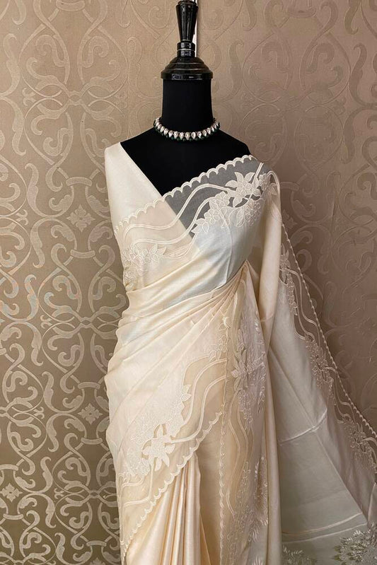 Off-White organza saree with tussar applique work and unstiched blouse, perfect for party wear by Saarang Sarees.