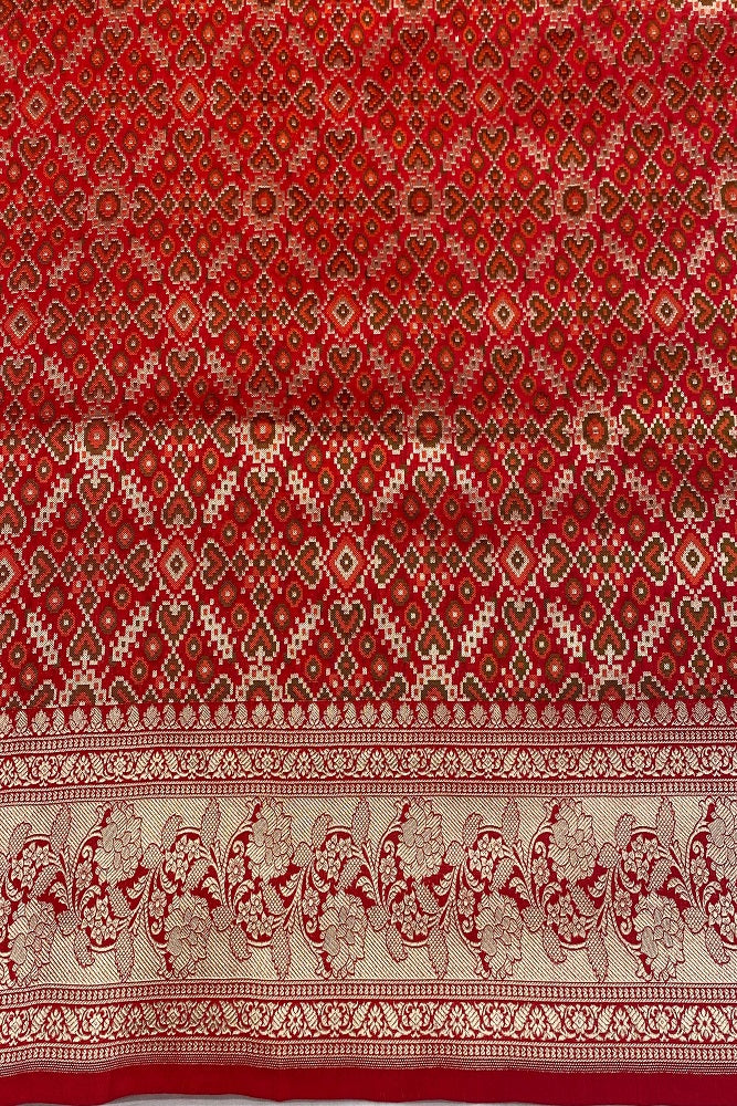 Red Uppada Banarasi saree with intricate gold zari work and an unstiched matching blouse, traditional wear by Saarang Sarees.