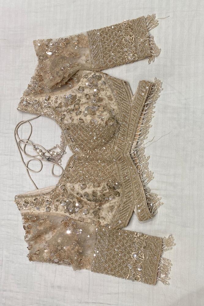 Off-White party wear net embroidered saree with matching readymade blouse, elegant traditional attire for festive occasions.