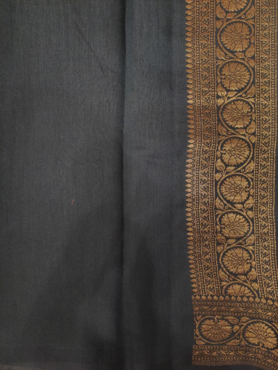 Off-White Munga Banarasi silk saree by Saarang Sarees with intricate gold patterns and a matching unstiched blouse for traditional wear.