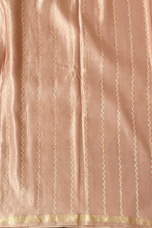 Peach pink Mashru silk Banarasi saree with intricate gold zari design and matching unstiched blouse, traditional Indian handloom wear.