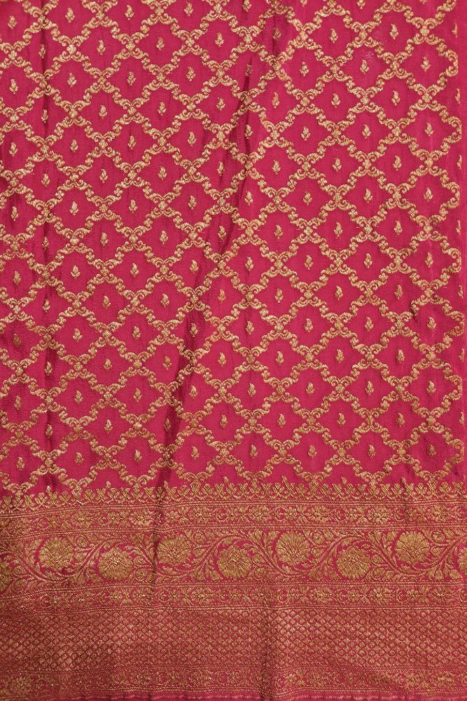 Deep green crepe Khaddi Banarasi silk saree with intricate gold zari work and matching unstiched blouse, traditional Indian attire.