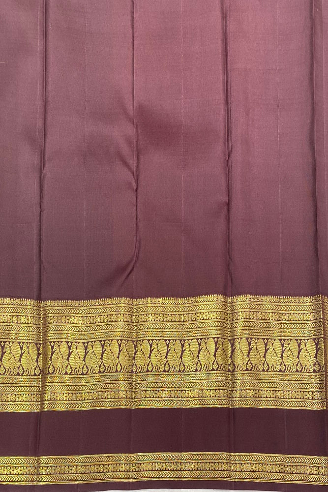 Orange Pure Kanjeevaram silk saree with traditional design and unstiched blouse from Saarang Sarees, displayed on a hanger.
