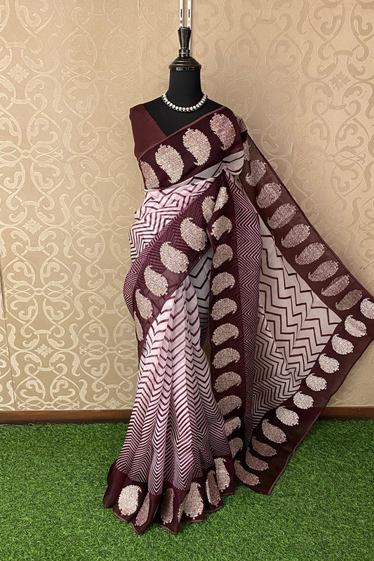 White and brown printed organza saree with pita zari border and unstiched blouse for party wear by Saarang Sarees.