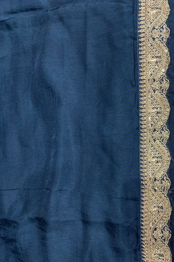 Navy blue organza silk saree with zari border, party wear style from Saarang Sarees, featuring intricate embroidery and elegant drape.