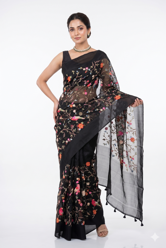 Black organza silk saree with cross stitch work and unstiched blouse, perfect for party wear by Saarang Sarees.