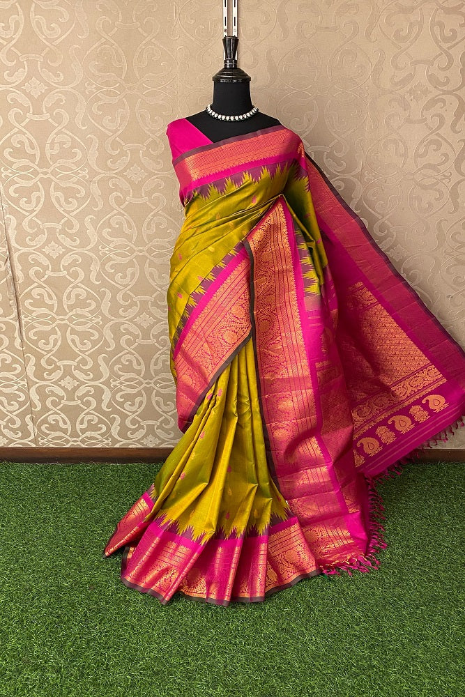 Golden lime green Gadwal silk saree with intricate border and blouse, traditional wear from Saarang Sarees.