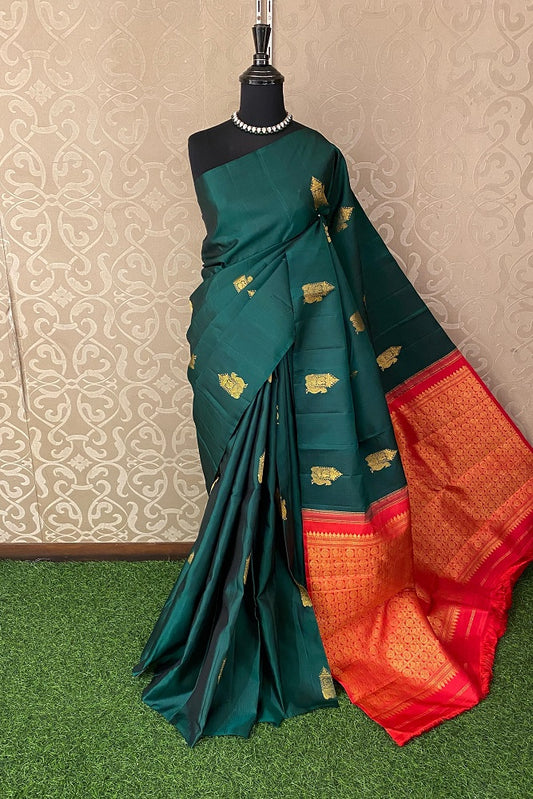 Bottle green pure Kanjeevaram silk saree with intricate gold zari work and matching unstiched blouse, traditional wear from Saarang Sarees.