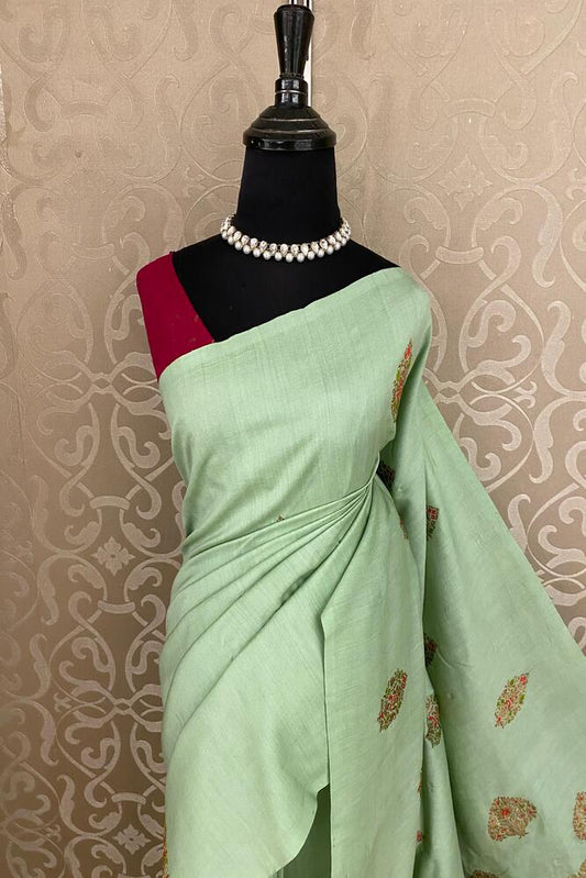 Pista green Munga Banarasi silk saree with intricate gold zari work and matching unstiched blouse for traditional wear.