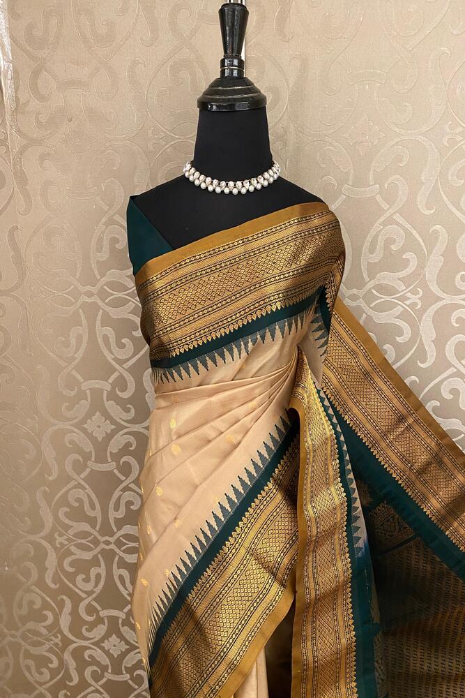 Beige Gadwal silk saree with intricate traditional designs and an unstiched blouse, showcasing elegant Indian craftsmanship.
