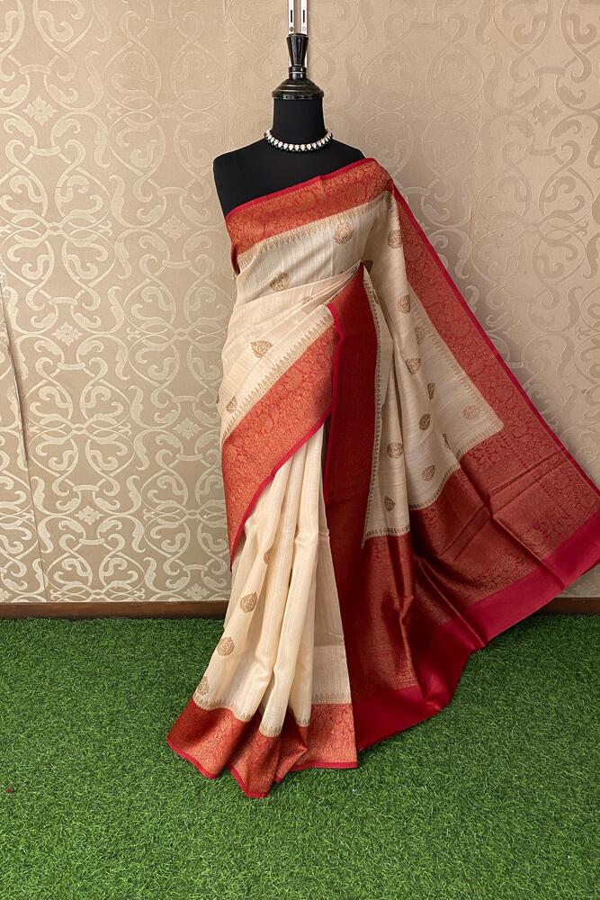 Off-White Tussar Banarasi silk saree by Saarang Sarees with hand-woven motifs and an unstiched blouse for traditional wear.