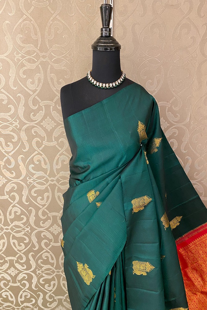 Bottle green pure Kanjeevaram silk saree with traditional zari borders and an unstiched blouse from Saarang Sarees.