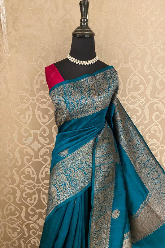 Teal blue Pure Raw Tussar Banarasi silk saree with handwoven motifs and an unstiched blouse, traditional wear by Saarang Sarees.
