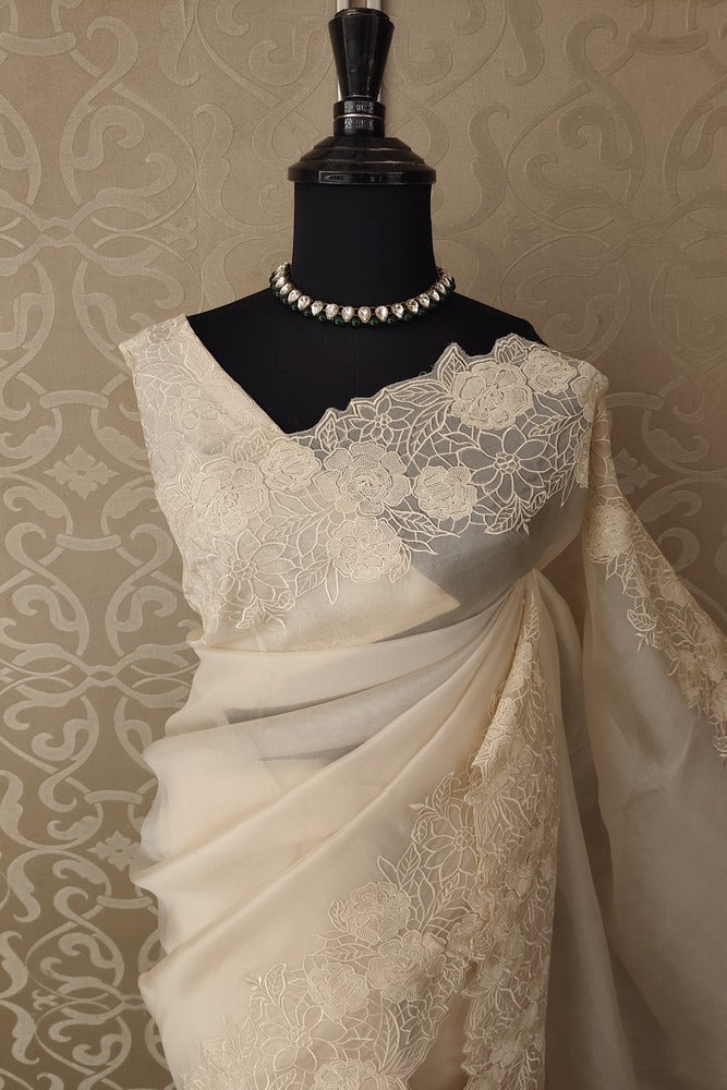 Off-White organza silk saree with resham embroidery and unstitched blouse, perfect for party wear from Saarang Sarees.