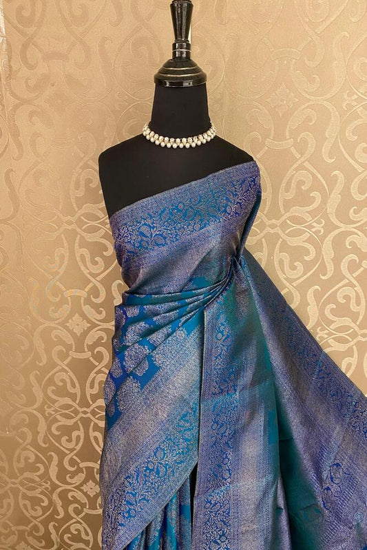 Peacock blue pure Kanjeevaram silk saree with intricate gold zari work and matching unstiched blouse, traditional wear by Saarang Sarees.