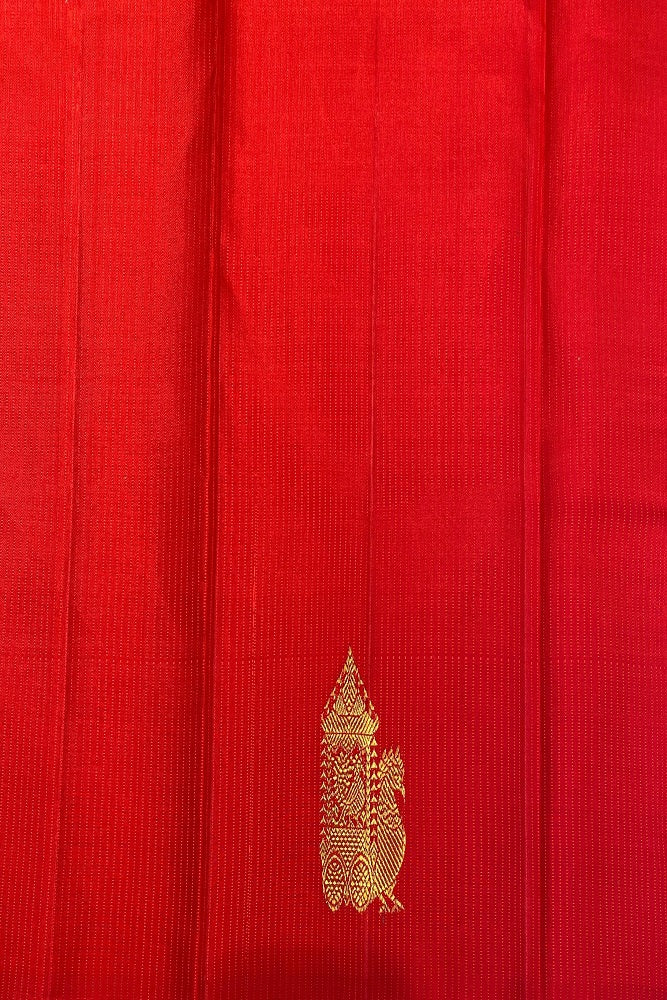 Bottle green pure Kanjeevaram silk saree with traditional design and unstiched blouse, displayed on a dress form.